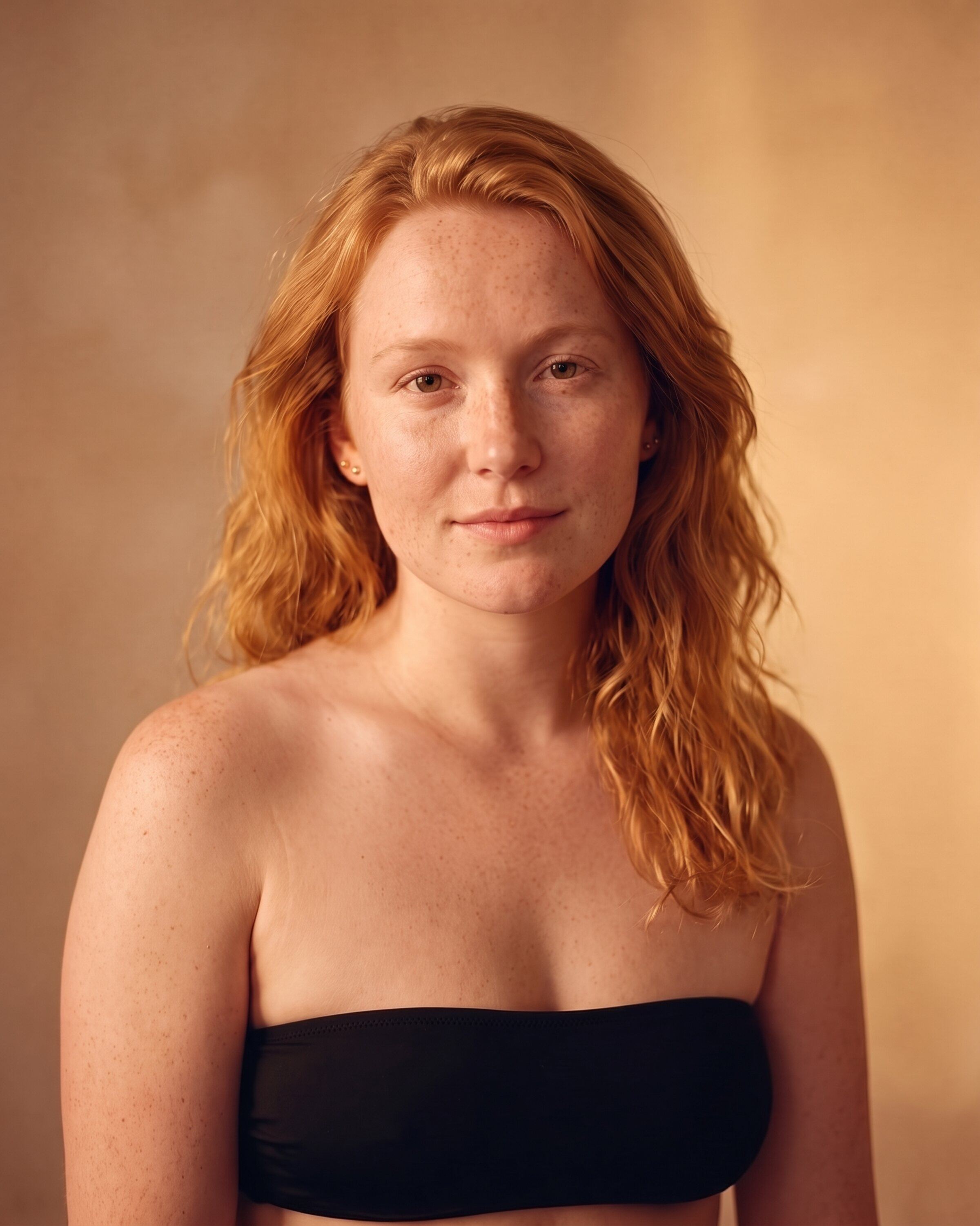 AI rendering: a woman with fair, freckled skin and wavy strawberry-blonde hair, untanned, before a custom spray tan