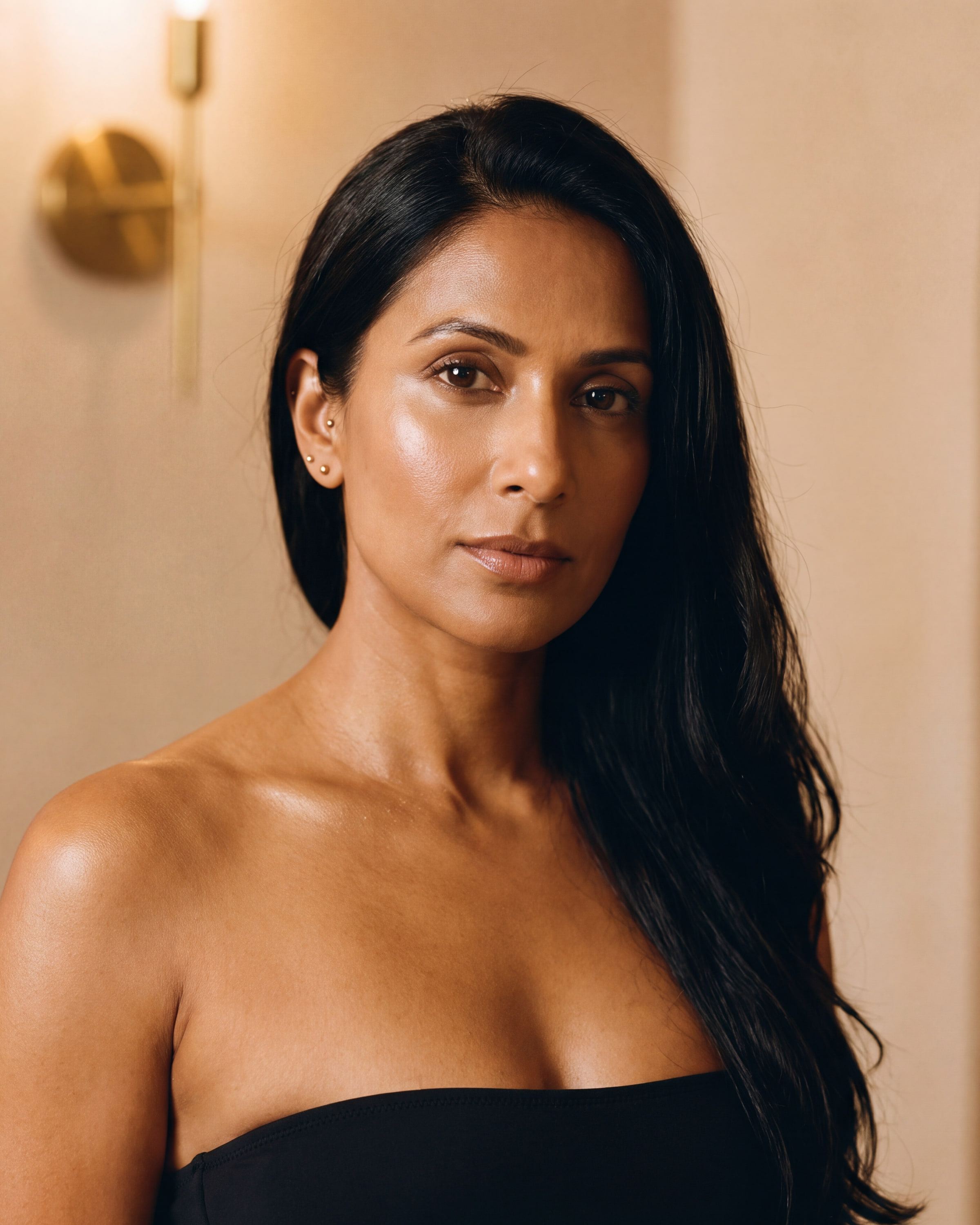 AI rendering: the same woman with warm beige skin after a custom spray tan